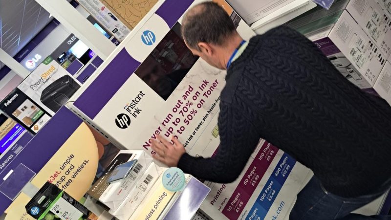 A member of the Retail Profiling display installation team creating a POS in Currys