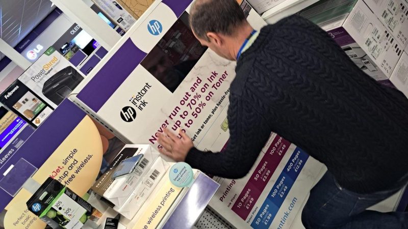 A member of the Retail Profiling branded spaces team creating a POS in Currys