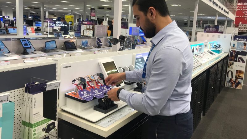 A member of the Retail Profiling display installation team creating a POS in Currys