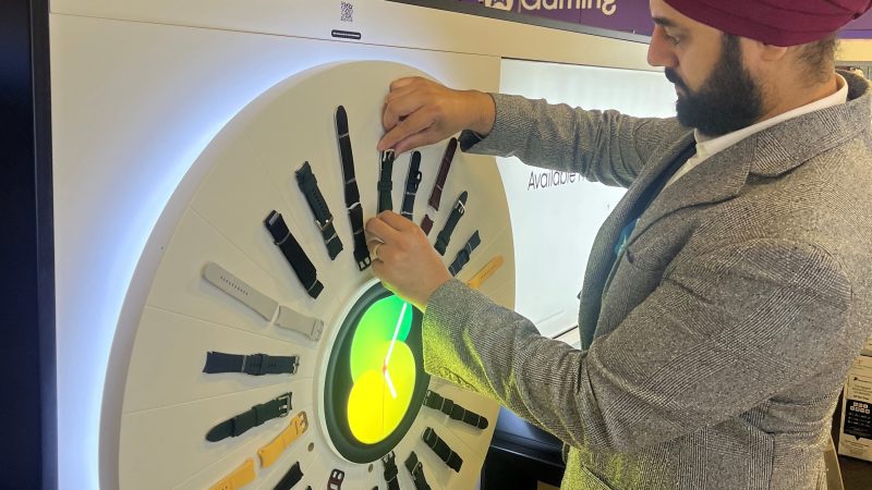 A member of Retail Profiling creating a display installation in store for Apple watches in Currys