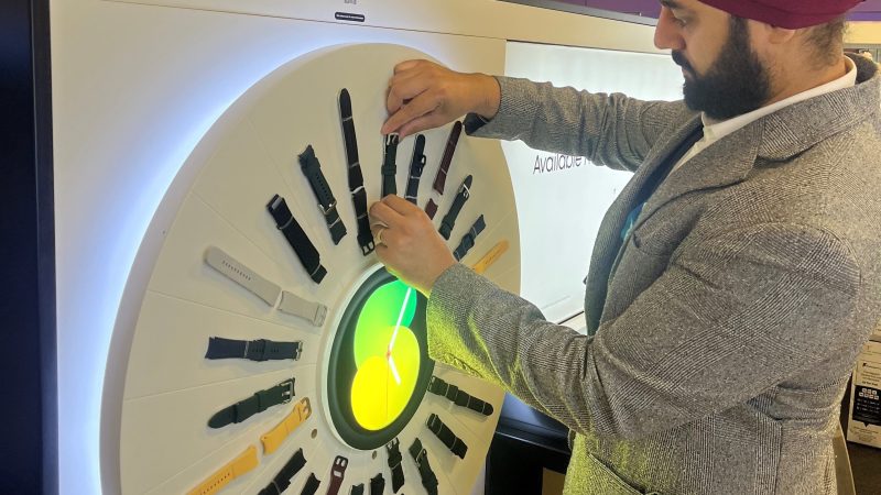 A member of Retail Profiling creating a display installation in store for Apple watches in Currys
